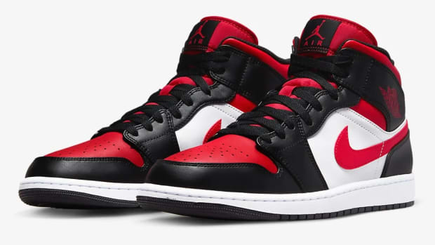 Detailed look at black and red Jordan shoes.